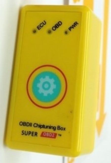 Close-up of a ChipPower OBD2 tuning box, marketed for car performance enhancement.