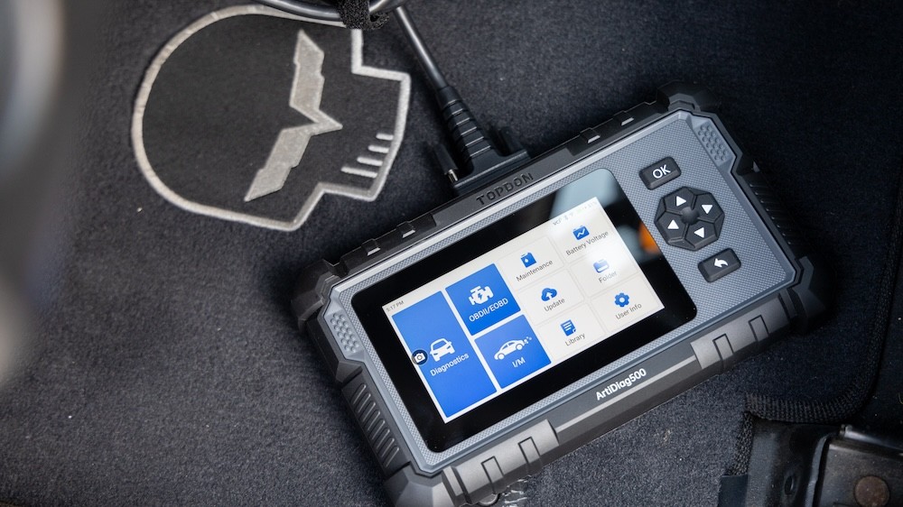 Hands-on review of the Topdon ArtiDiag500 OBD2 scanner, a budget-friendly tablet-style scan tool showing diagnostic data on its display, perfect for car enthusiasts and home mechanics.