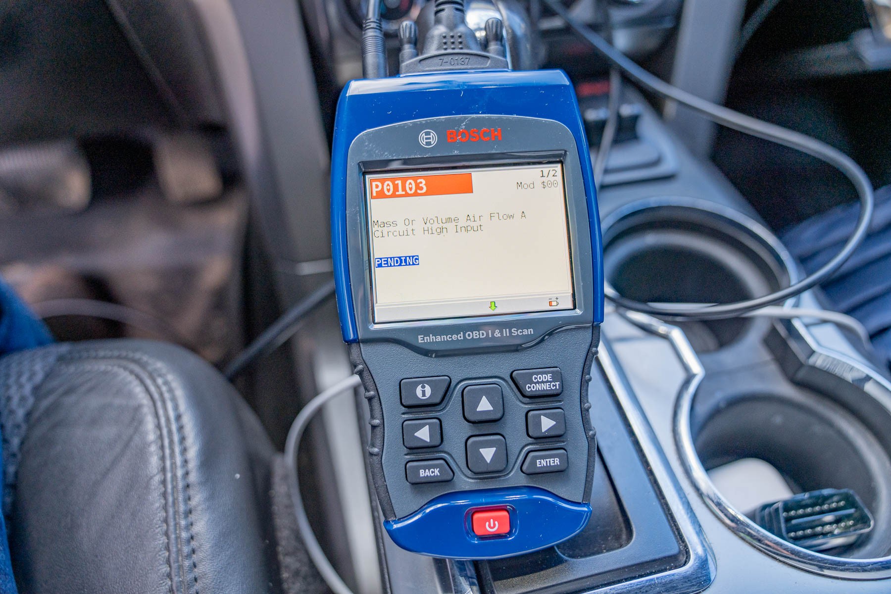 Bosch 1300 OBD scanner being used in a vehicle