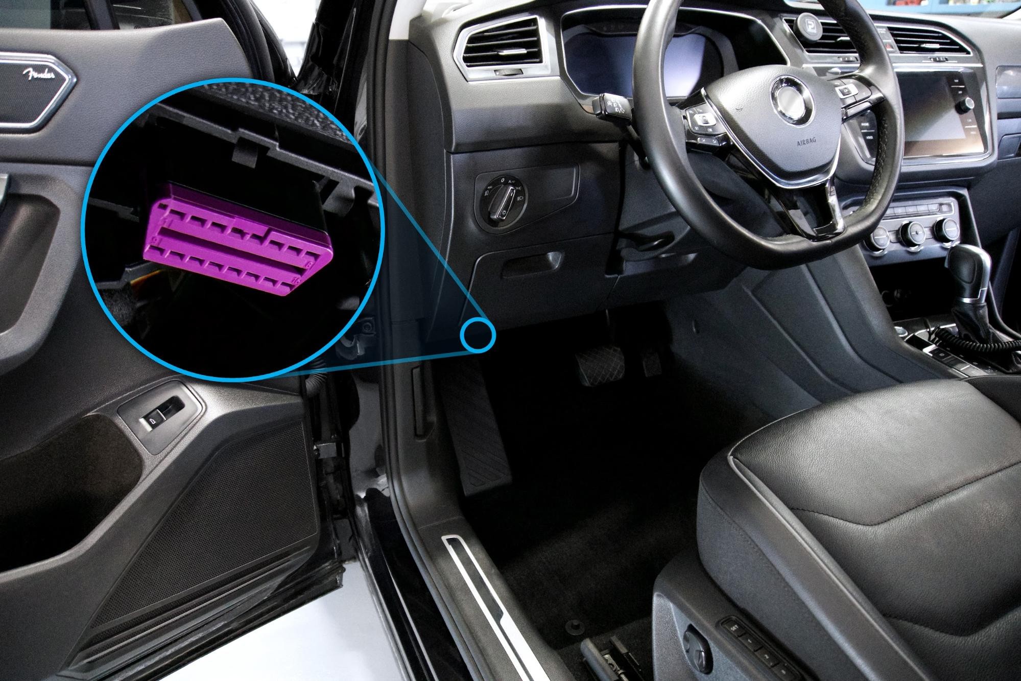 Location of the OBD2 port under the dashboard on the driver's side of a vehicle.