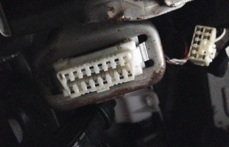 Close-up view of a DLC3 connector with visible pins, used in some Toyota vehicles, highlighting potential OBD-II compatibility questions.