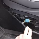 OBD2 port location in the rear footwell of older Tesla Model Y models