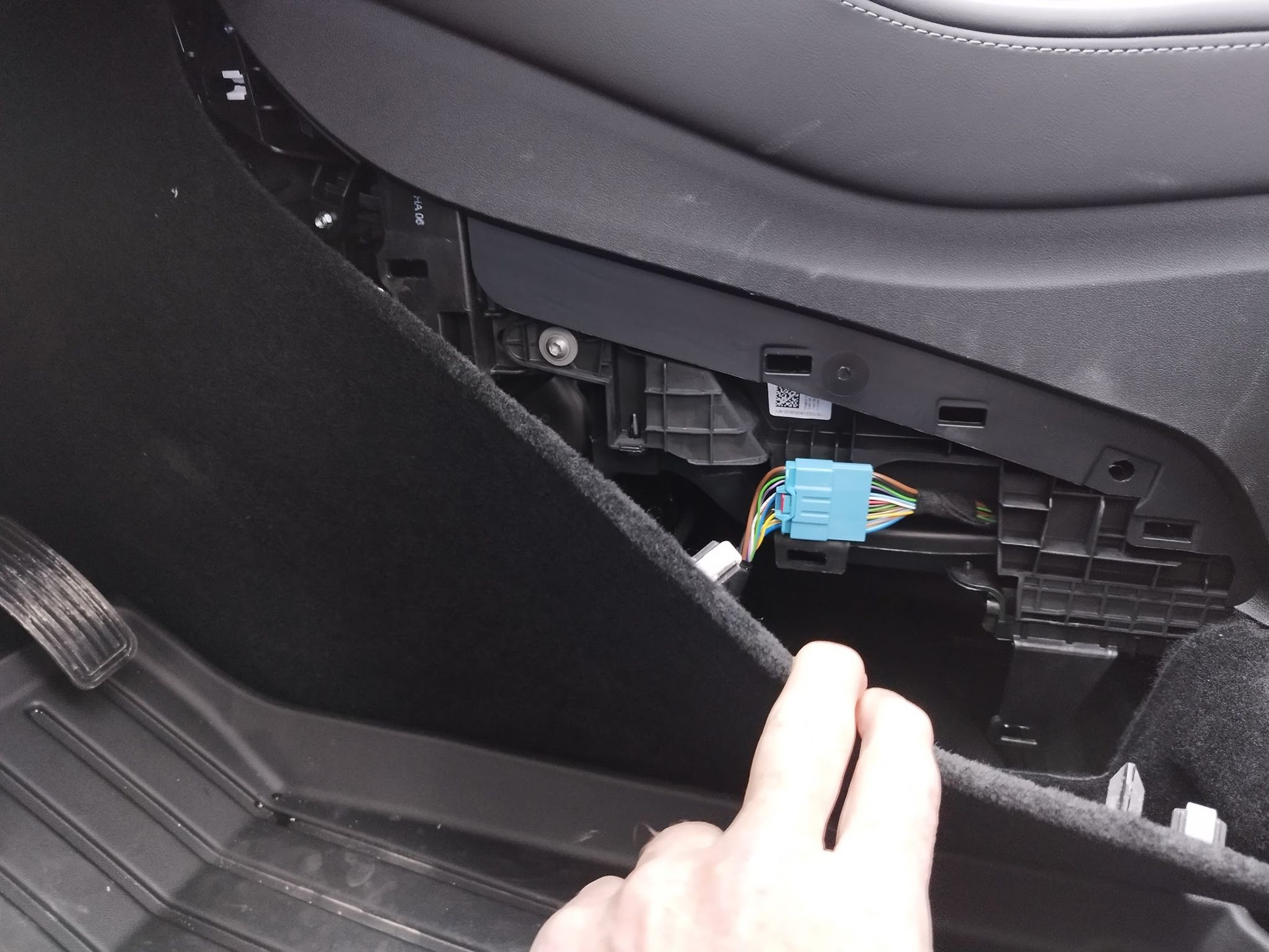 OBD2 port location in the rear footwell of older Tesla Model Y models